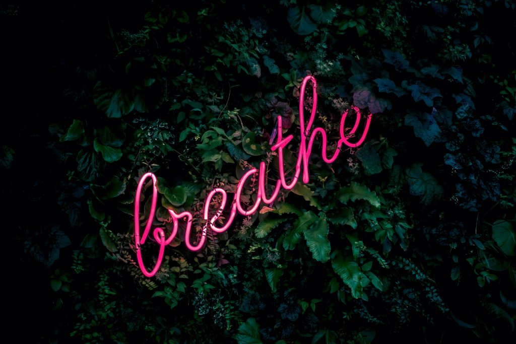 A neon sign reading "breathe". Just breathe: step 3 of 5 basic steps for meditation