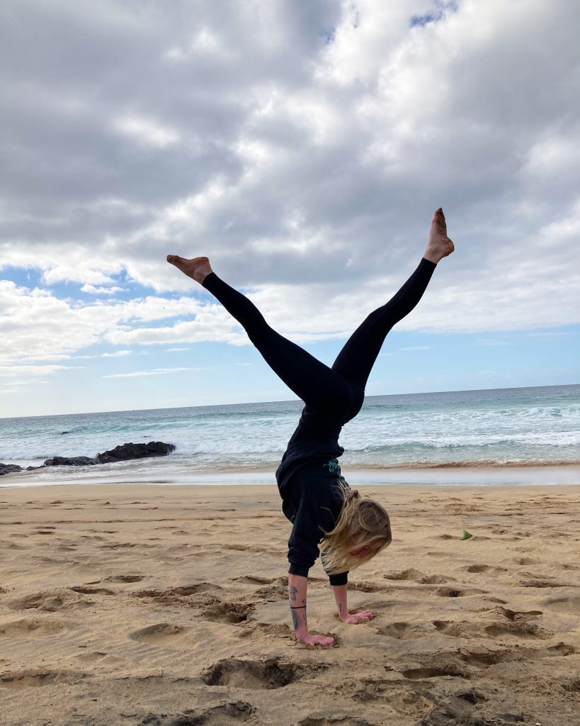 Me practicing handstand by the beach with the ocean in the background in Fuerteventura - this is my happy place. 