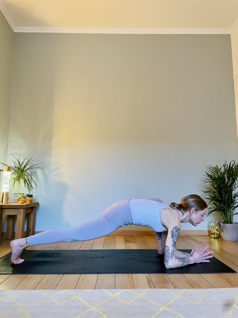 Image depicting woman practicing the yoga pose, lizard, which is a great hip opener for the inner tights and hip flexors.