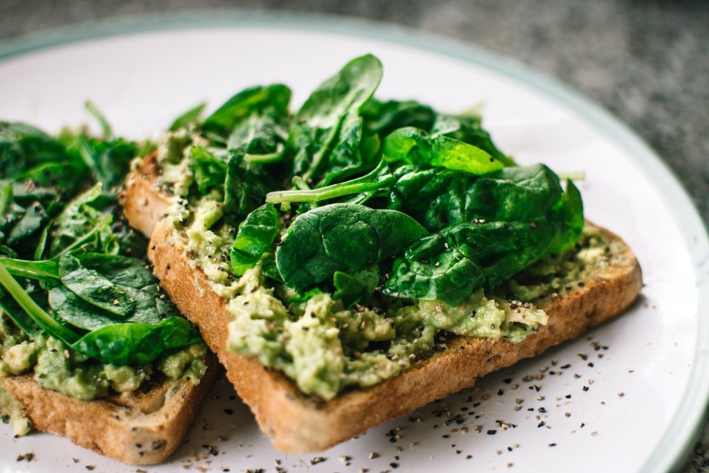 Image depicting a toast sandwich with spinach. Spinach is a dark leafy green and can help fight depression.