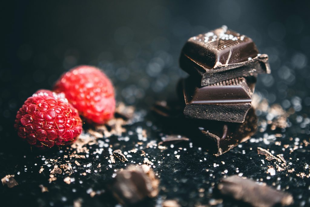 Image showing squares of dark chocolate and raspberry. Dark chocolate is also s great food for depression.