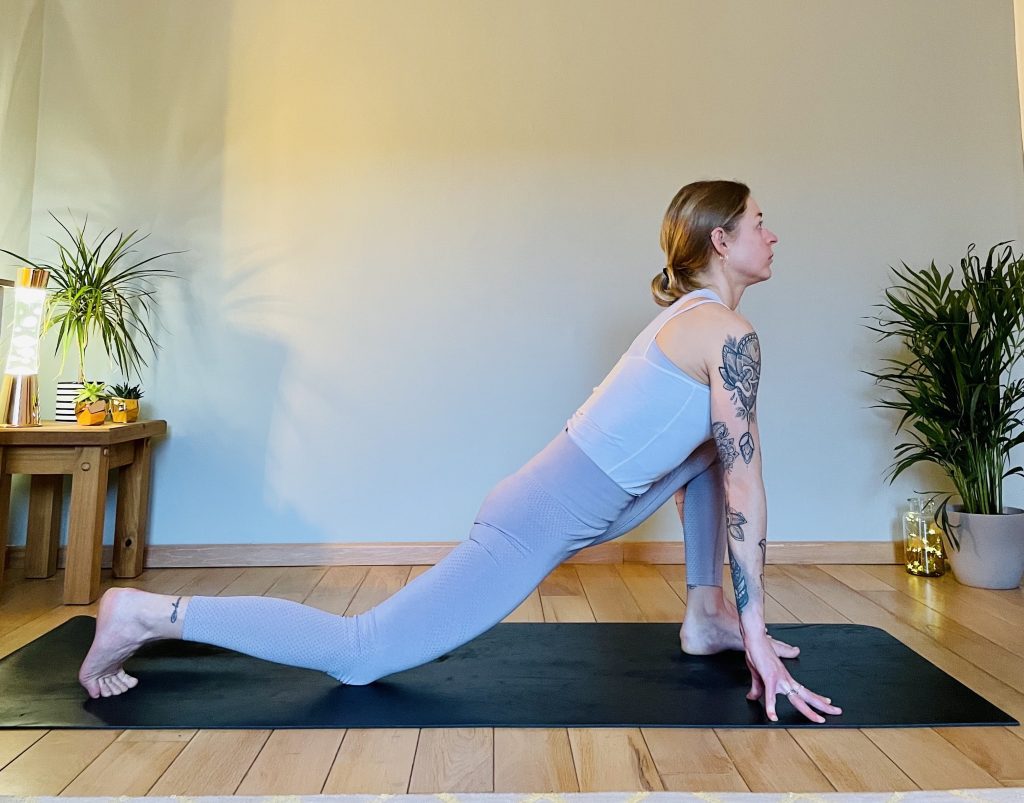 Image showing a girl practicing a variation of Anjaneyasana - low lunge. Low lunge opens the front thighs and hip flexors and can help reduce lower back pain.