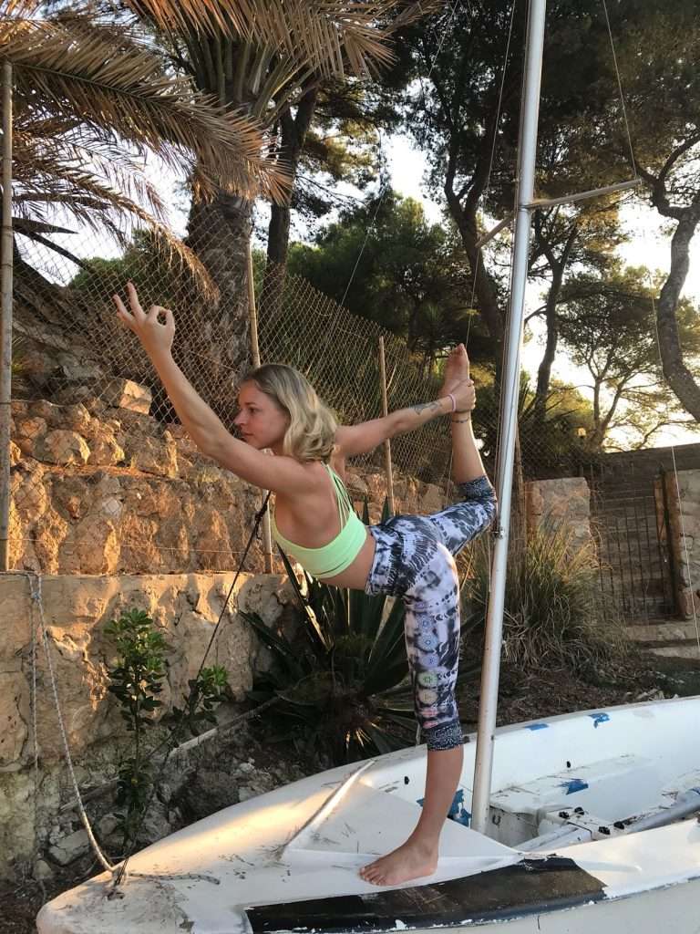 Girl practicing the yoga pose dancer - Natarajasana - in a city outside. Natarajasana is a good 'peak pose' that can serve as the focus when sequencing a yoga class.