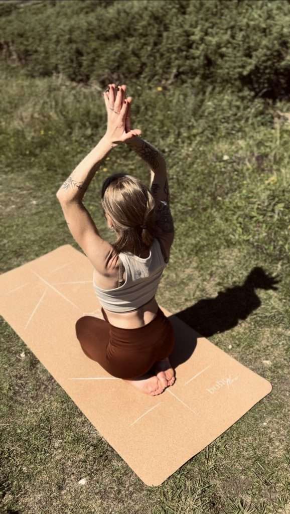 Picture showing young girl in a seated, reflective yoga pose. Yoga and exercise are important aspects of physical self-care.